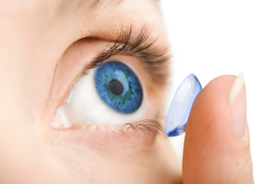 Person putting in contact lens